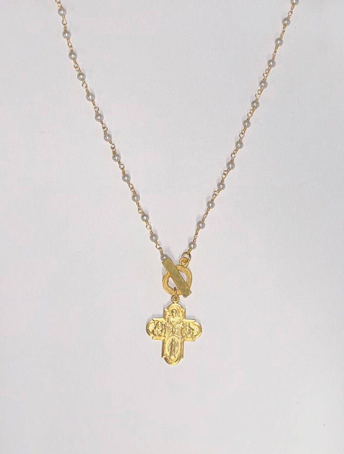 Gold cross necklace with engraved design
