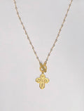 Gold cross necklace with engraved design