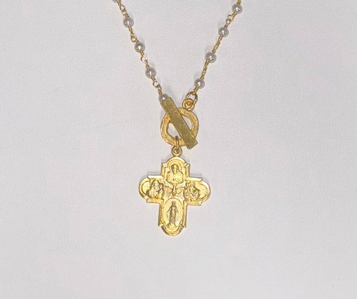 Close up of gold necklace with engraved design