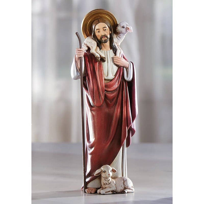 Shepherd Jesus with lamb at feet and carrying lamb on table