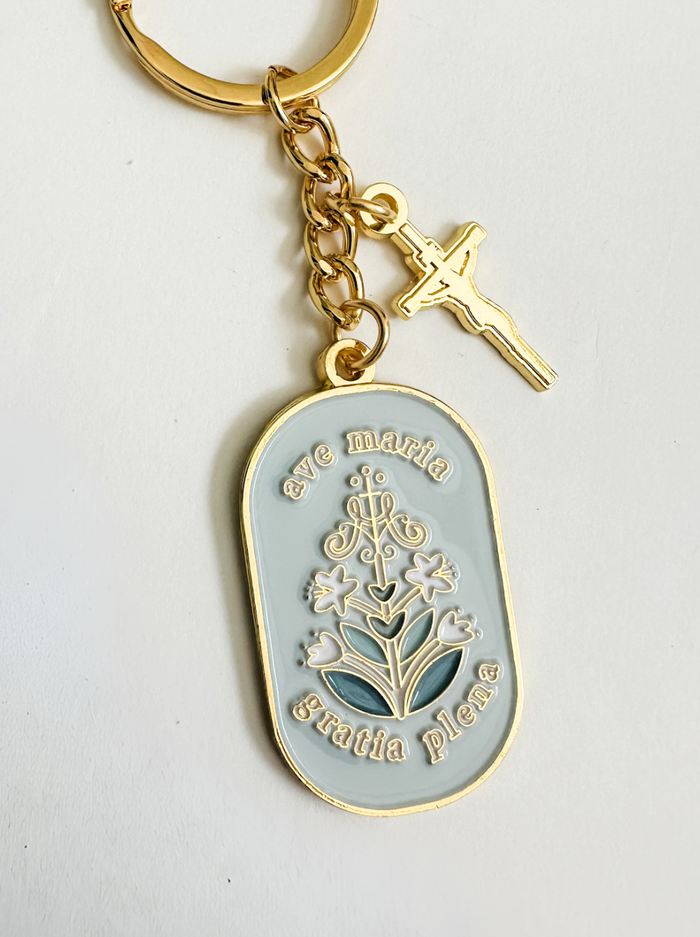 Light blue floral design with golden border and gold chain and gold crucifix