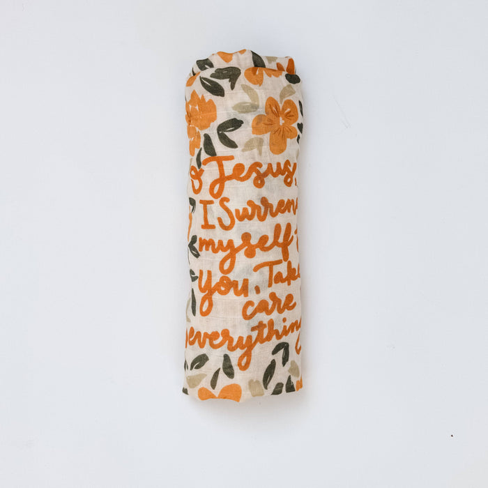 Floral-patterned swaddle blanket with text on a white background