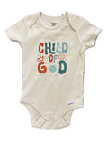 Baby onesie with colorful text design on a floral-patterned surface