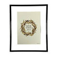 Framed artwork with a wreath of thorns and text on a beige background