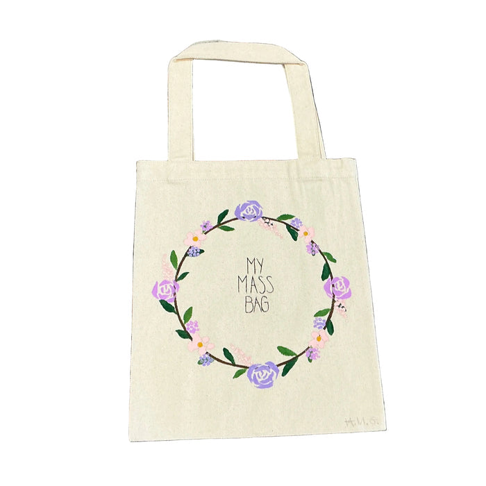 Beige tote bag with floral design and text on a textured floral background