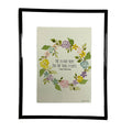 Framed artwork with floral design and text on a white background