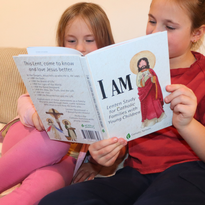 Two children reading a book titled 'I AM' about Lenten studies for Catholic families with young children.