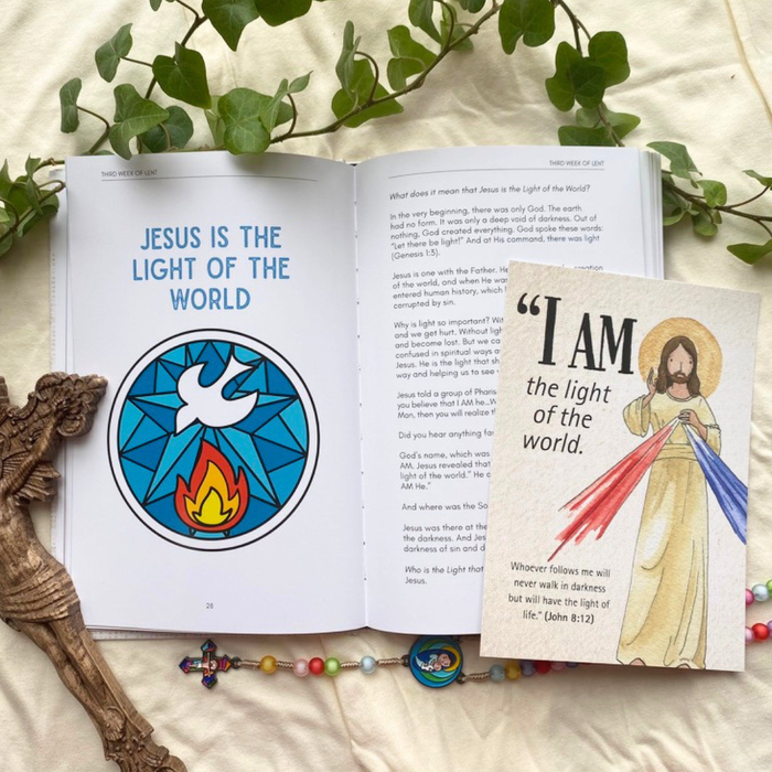 Open book with religious illustrations and text on a light background