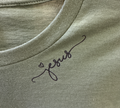 Green shirt with 'Jesus' embroidered on it