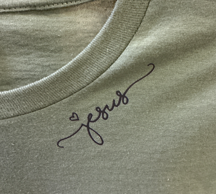 Green shirt with 'Jesus' embroidered on it
