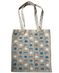 Tote bag with floral and letter pattern on a beige background