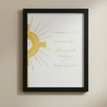 Framed artwork with a gold design and text on a white surface
