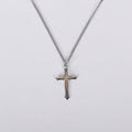 Cross pendant necklace on a light gray background