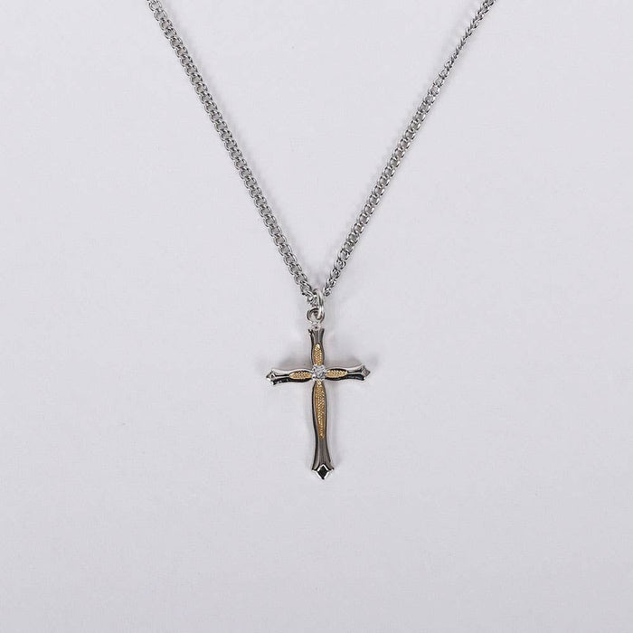 Cross pendant necklace on a light gray background