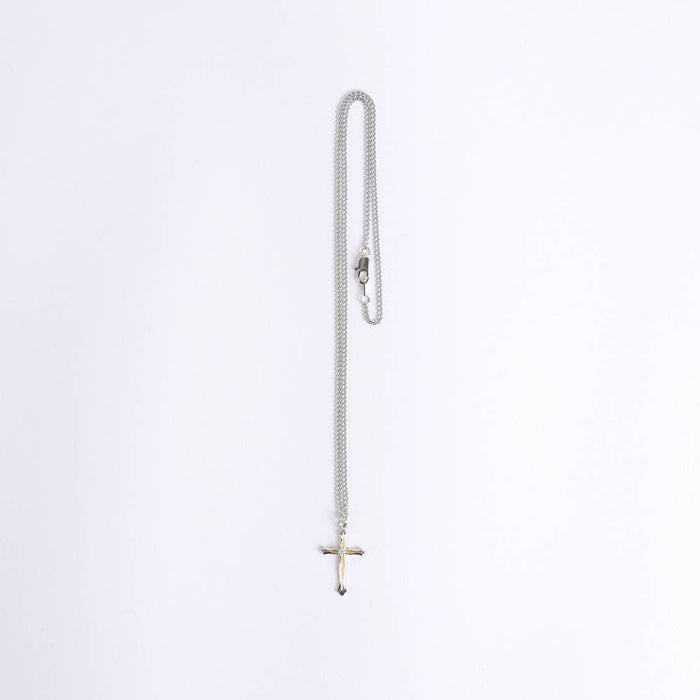 Silver chain necklace with a cross pendant on a white background
