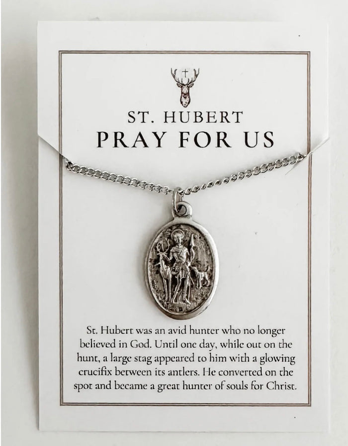 Silver St. Hubert necklace on a card with text