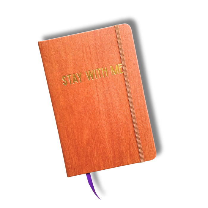 Orange book with 'Stay With Me' text on a white background