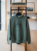 Green hoodie with 'Verso L'Alt' logo on a mannequin against a fabric background
